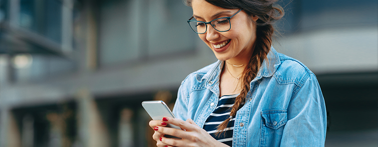 happy woman looking at phone