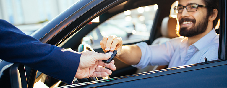 happy guy in car accepting keys